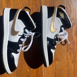 Boys Nike Jordans in size 3Y in white with gold swoosh and black accents.